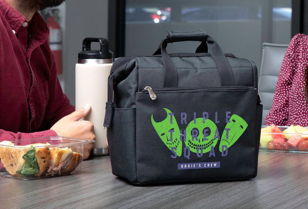 Black lunch tote with “Triple Threat Squad” graphic on a table beside food containers and a water bottle.