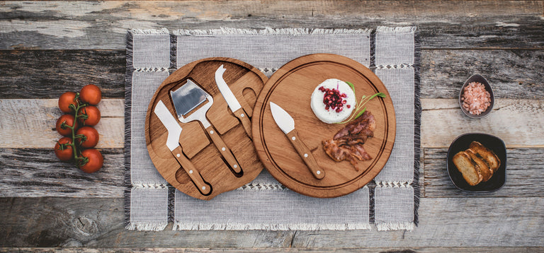 cheeseboard and tool set on the table with meat and cheese on the board