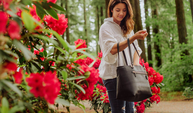 woman in flowers with cooler bag